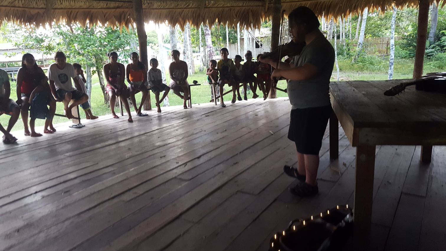 Fionn playing traditional Irish music for the local community in the Amazon Rainforest. Fionnathan