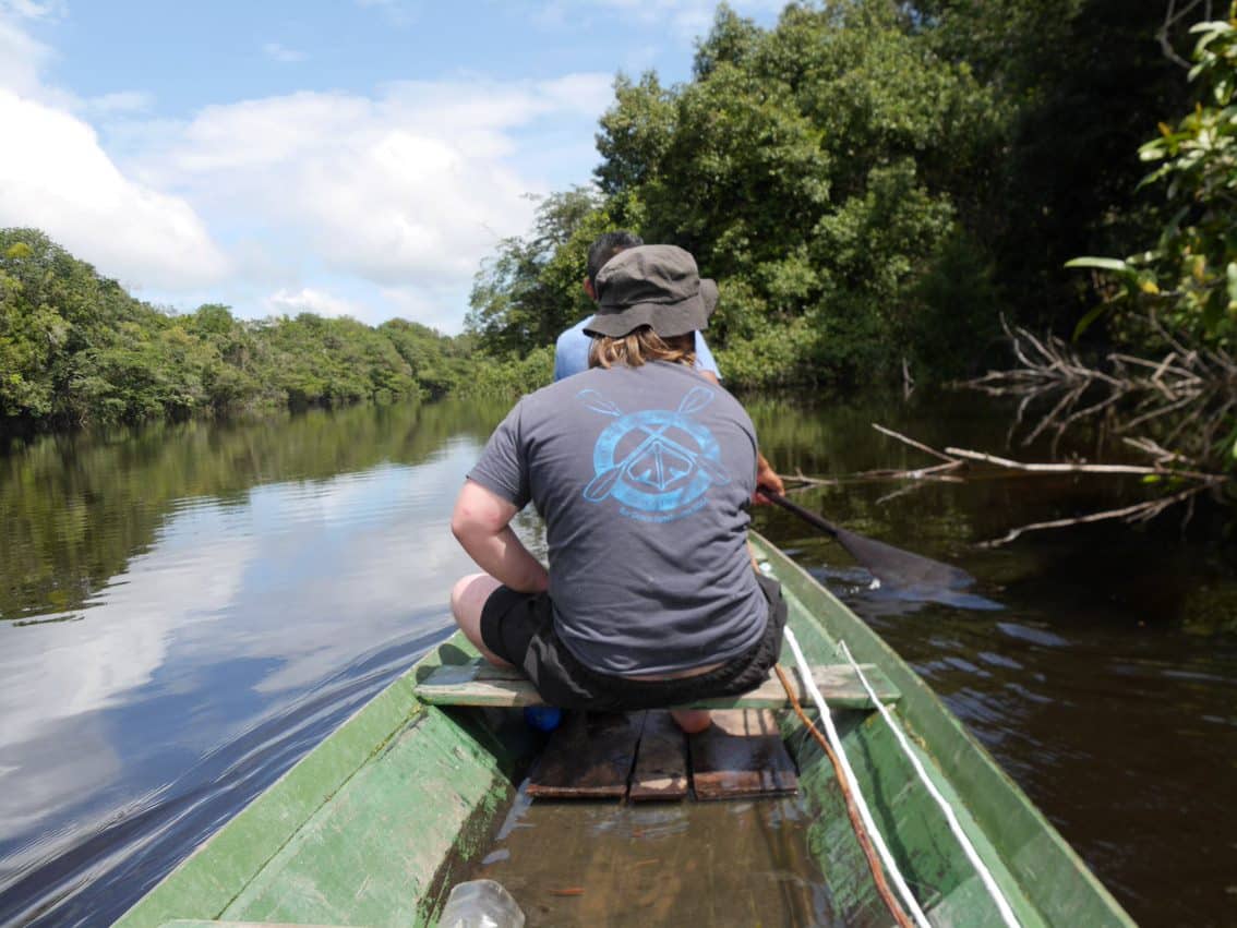 Fionn in a dugout canoe in the Amazon Rainforest.